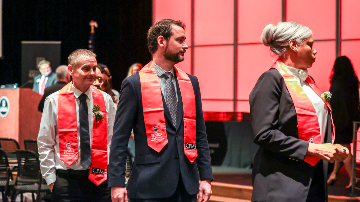 CPM graduates line up to receive their certificates at their graduation ceremony.