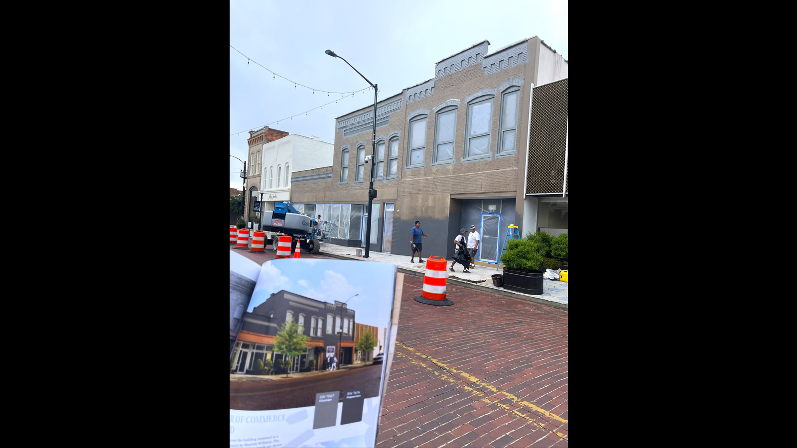 Photo of building getting a facelift with proposed design held in front.