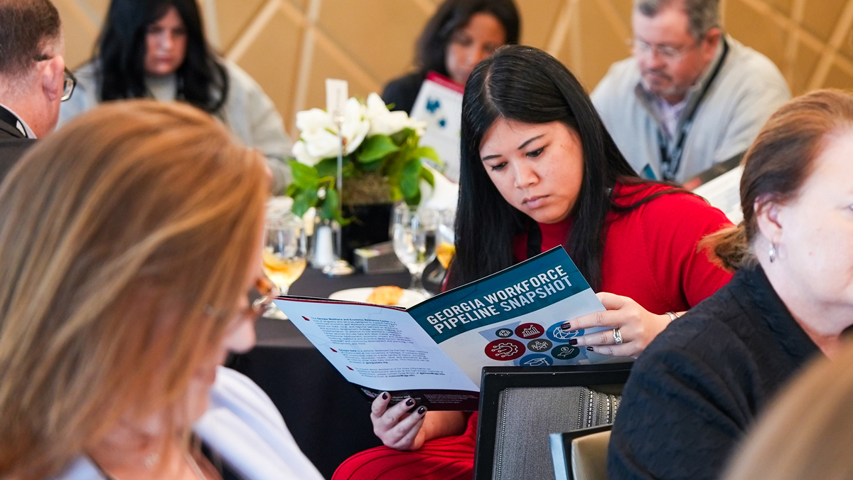 attendees at conference reading a handout
