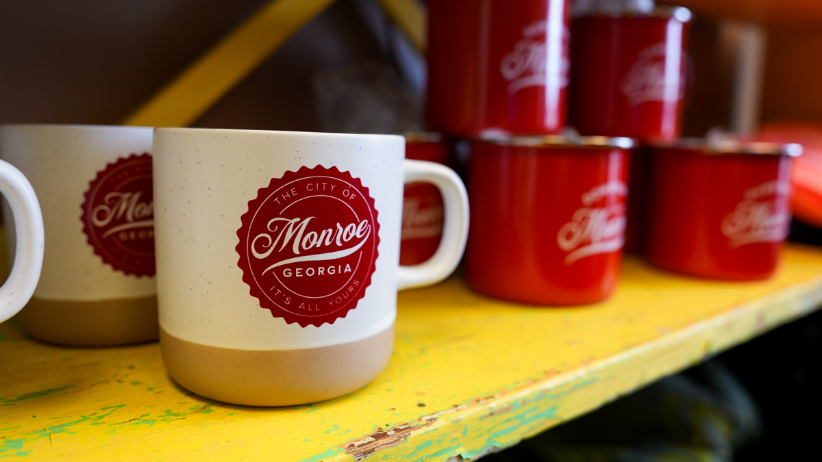 The city’s iconic circle logo with a bottlecap border graces everything from mugs and stickers to murals and banners.