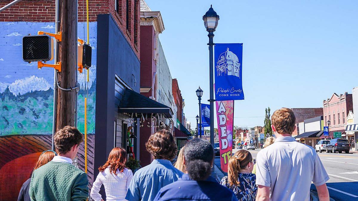 A group of students walk through downtown Hawkinsville.